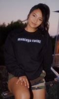 Myka Montoya wearing a black crewneck sweatshirt from the Montoya Twinz Label Black Friday Release campaign