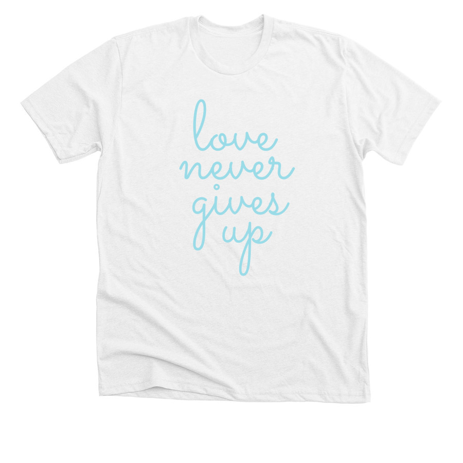 white shirt with love never gives up scripted text